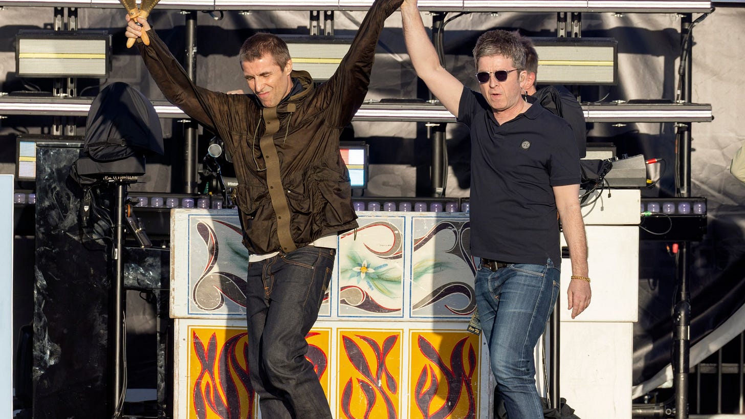 Liam and Noel Gallagher hold hands on stage as Oasis return to Manchester  for the first time in 16 years at hometown gig | The Sun