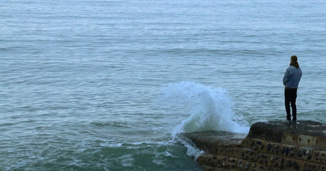 brown rock formation on sea during daytime brown rock formation on sea during daytime