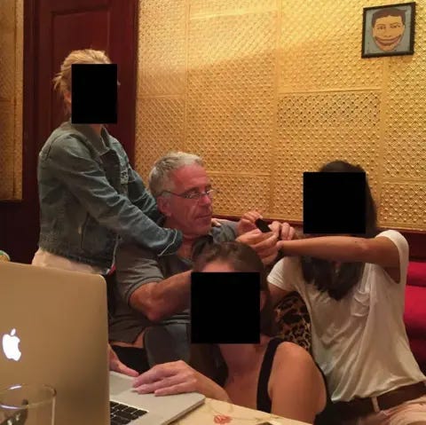 House Oversight Committee Epstein sitting at a desk closely surrounded by three female figures - whose faces have been redacted - one of whom has her hand on Epstein's chest under his shirt, and another who is crouching to look at a laptop.