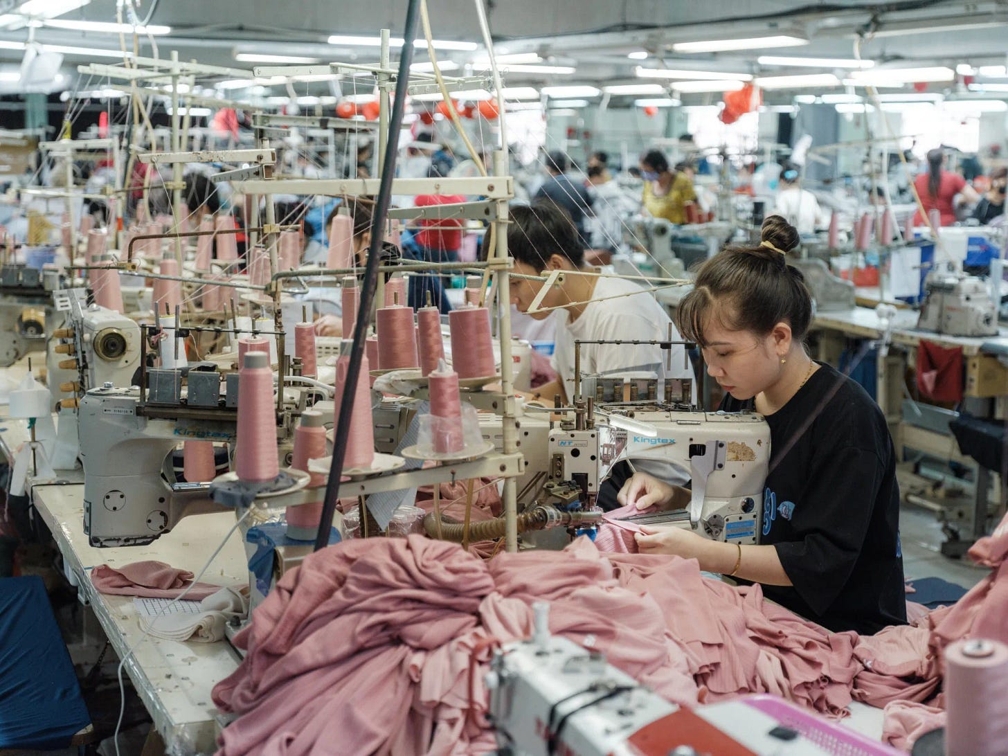 Workers operate sewing machines at a garment factory in Binh Thuan province, Ho Chi Minh City, Vietnam.