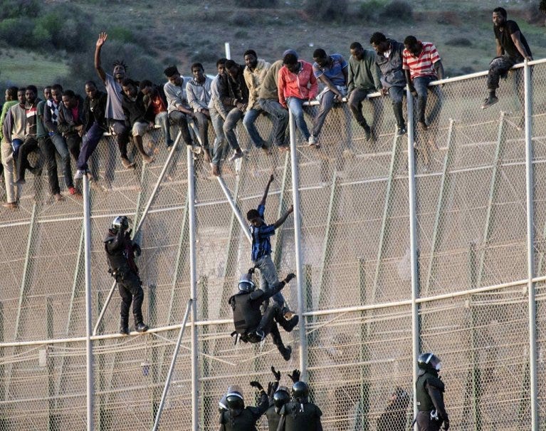 From file: Migrants climb the fence on the border between Melilla and Morocco | Photo: Reuters