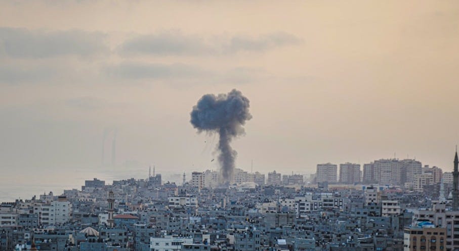 smoke billows from a factory in a city