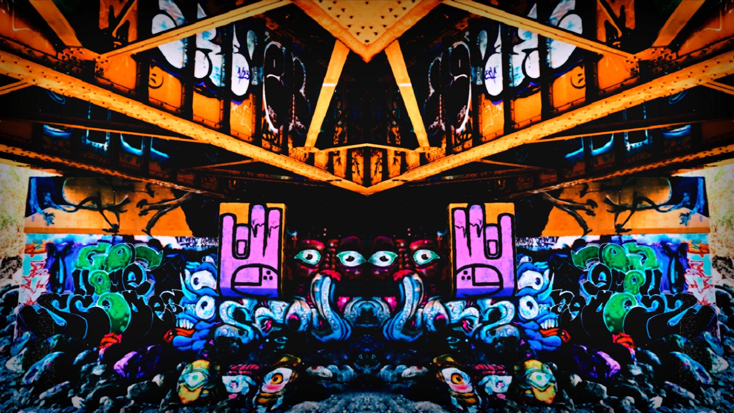 A photo I took of under a bridge in some lonely place in the mountains. The entire bridge is tagged and graffiti art is painted all over it. Some are hands with a mi vida loca tattoo, some are eyes and ghouls.