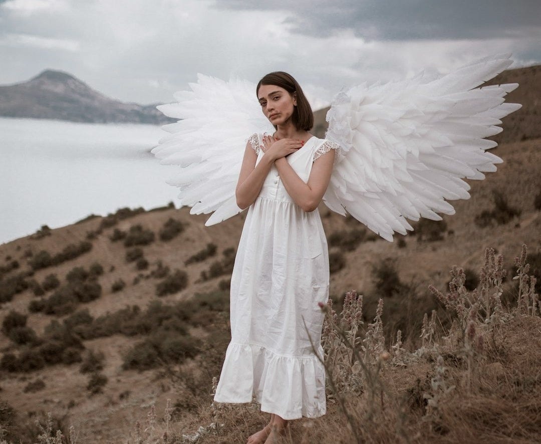 woman in white dress standing on brown grass field near body of water during daytime woman in white dress standing on brown grass field near body of water during daytime