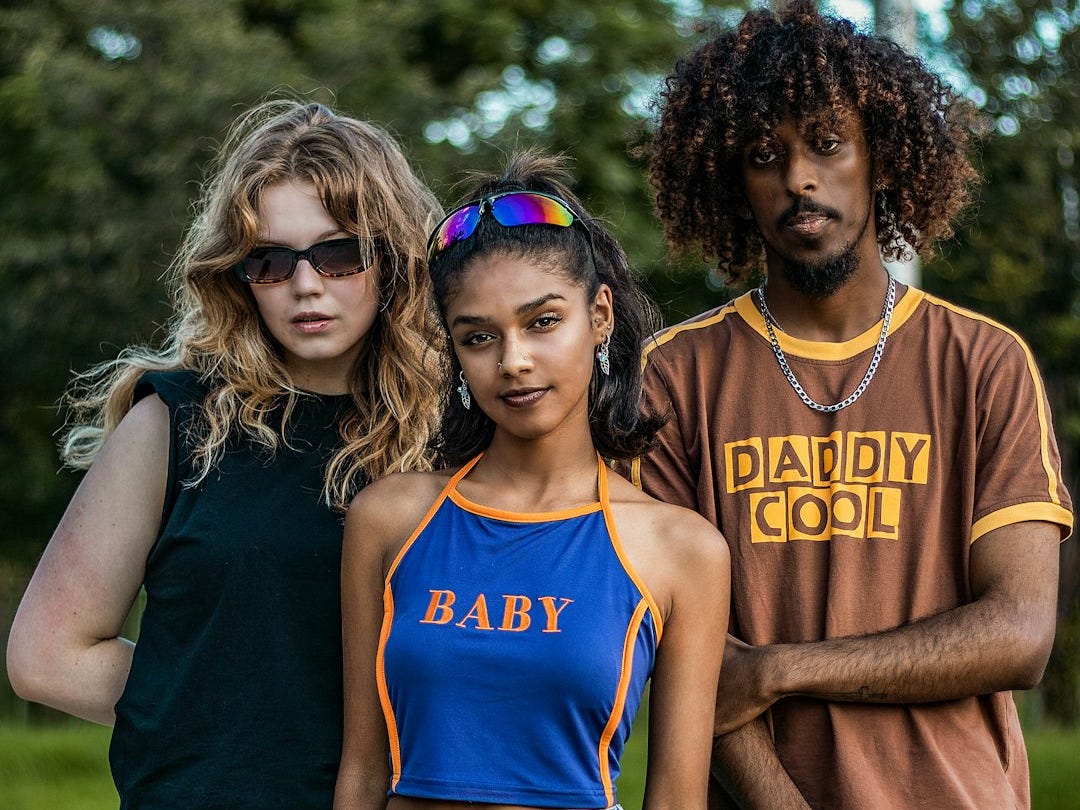 a group of three people standing next to each other