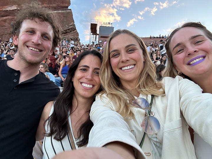 ashley wearing sunglasses looking at a cloud-filled sky, maggie rogers concert screen that say "I always find my way back to my feet," maggie rogers playing guitar