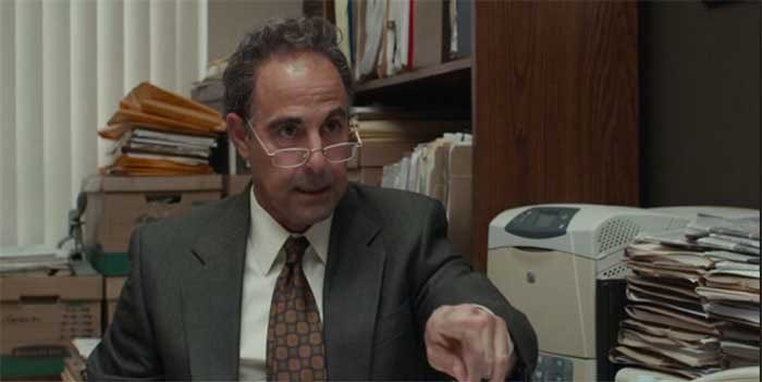 an image of stanley tucci surrounded by files from the movie SPOTLIGHT