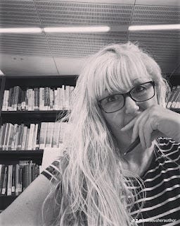 me in the library, writing, with a pen in my hand