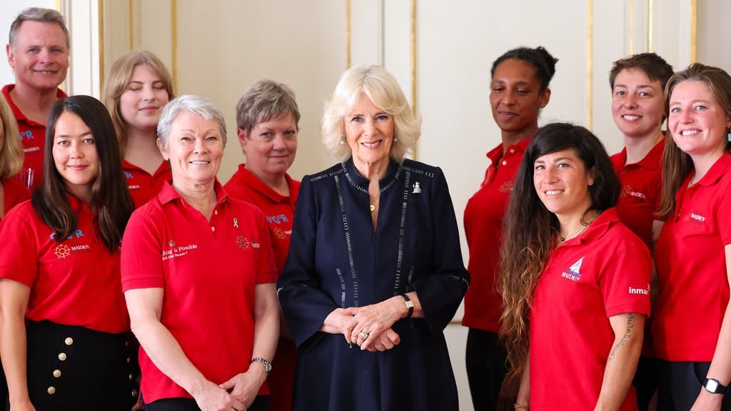 Queen Camilla speaks to crew members