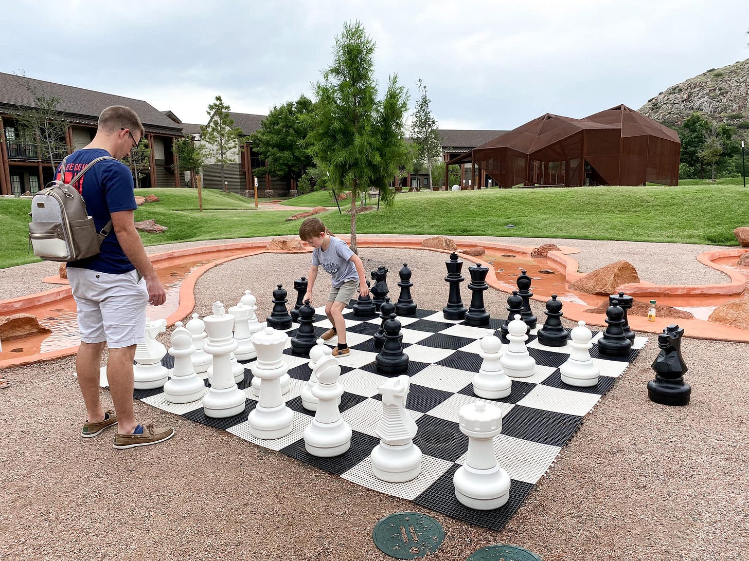 May be an image of 2 people and chess