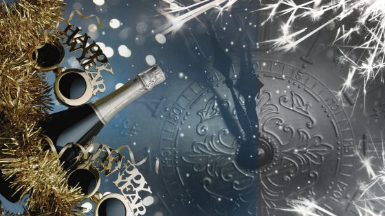 Sparklers shoot across the face of an old embossed clock, minutes away from striking twelve. A champagne bottle, gold tinsel, and sunglasses crowned with Happy New Year wait at the ready.