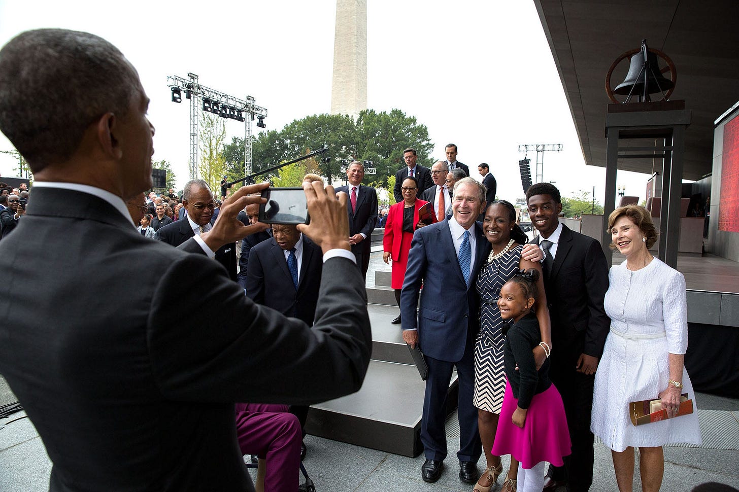September 24, 2016: A truly unique photo op: former President George W. Bush hands his phone to President Obama, asking him to snap a picture of the Bonner family (descendants of an escaped slave) with the Bushes, at the African American Museum opening. September 24, 2016: A truly unique photo op: former President George W. Bush hands his phone to President Obama, asking him to snap a picture of the Bonner family (descendants of an escaped slave) with the Bushes, at the African American Museum opening.