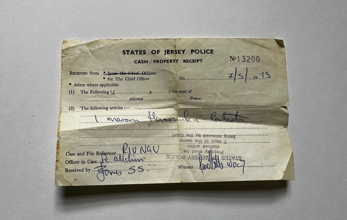 old and worn receipt from the States of Jersey Police for 1 maroon rucksack, dated may 1979