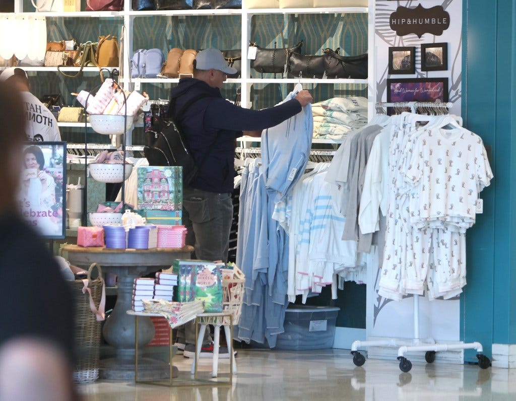 Mike Vrabel is seen shopping for a woman's sweat suit at Salt Lake City airport, wearing his wedding ring.