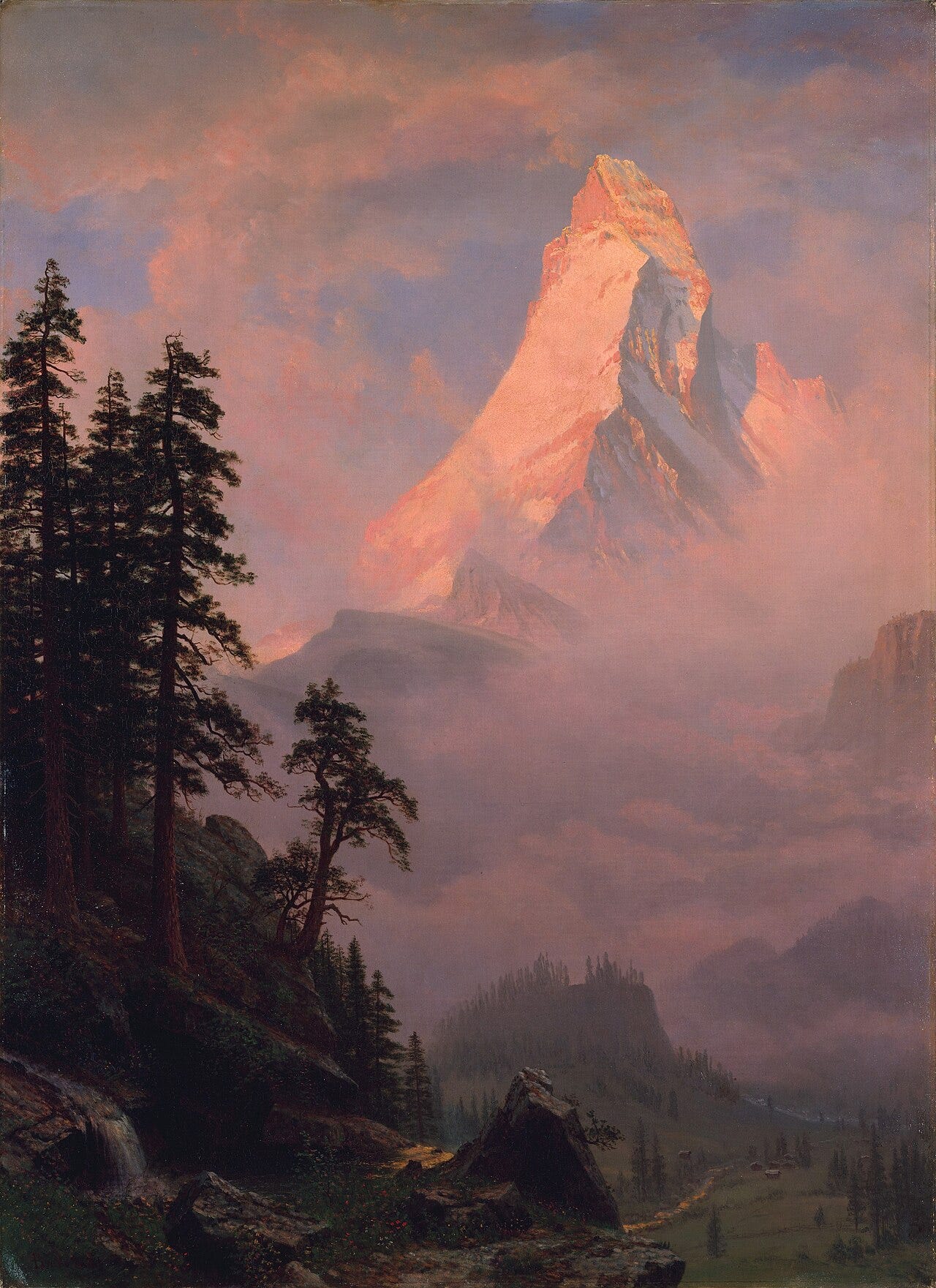 Bierstadt's Sunrise on the Matterhorn, the peak wrapped in cloud far behind a rocky foreground