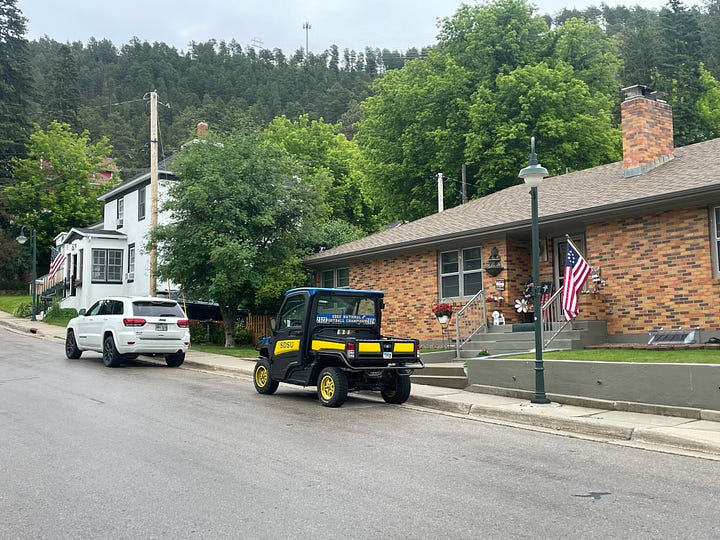 A nice little house with a golf cart in front and another photo of a strip mine.