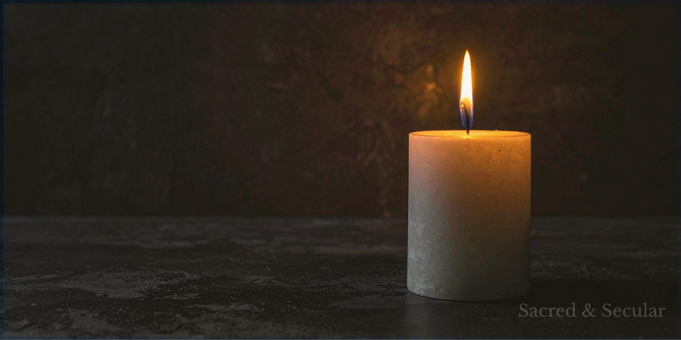 A single lit candle glowing in a dark room, with the surrounding space fading into shadow. The warm flame creates a small pool of light, symbolising hope, guidance, mystery and the search for understanding. A single lit candle glowing in a dark room, with the surrounding space fading into shadow. The warm flame creates a small pool of light, symbolising hope, guidance, mystery and the search for understanding.