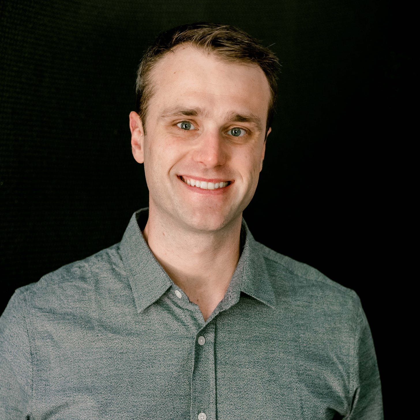 A man smiles at the camera