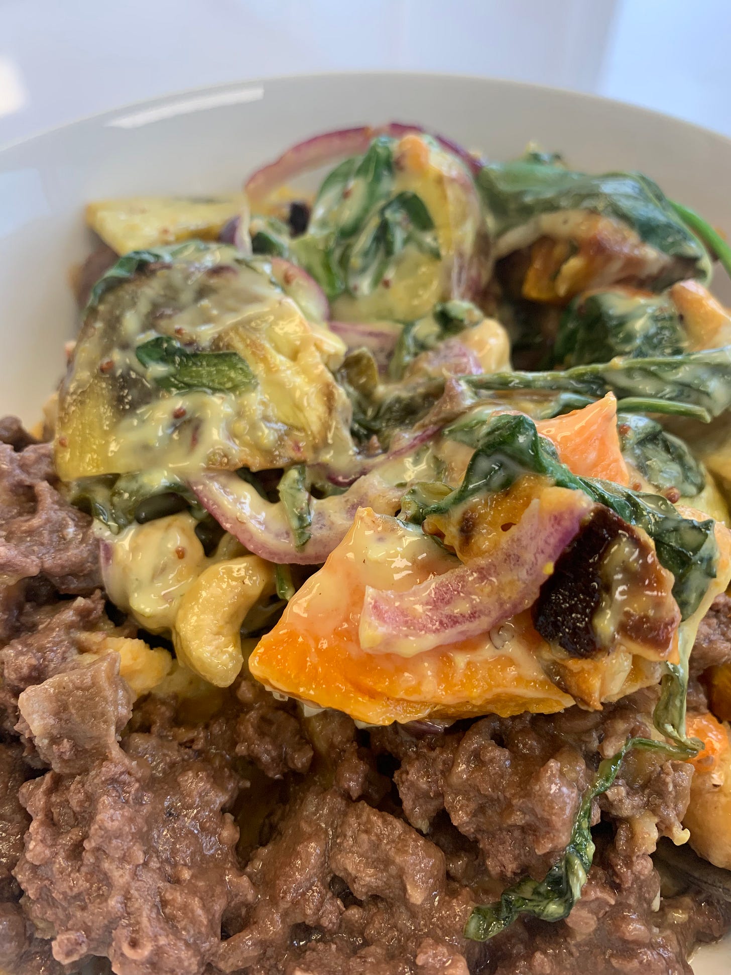 Cottage pie with kumara and cashew salad on top. Cottage pie with kumara and cashew salad on top.