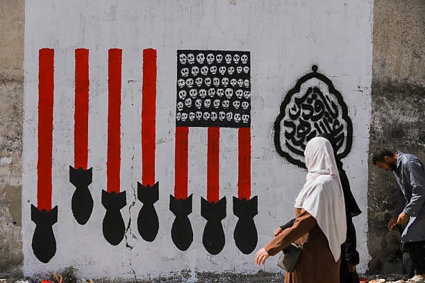 Group of Palestinian muralist youths paint a mural to demonstrate US supply of arms to Israel, in Gaza, Palestinian territories on March 28, 2025.