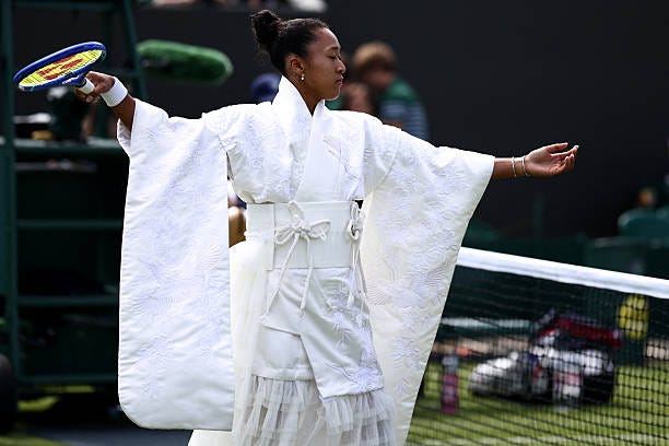 Japan's Naomi Osaka warms up ahead of her women's singles first round tennis match on the first day of the 2026 Wimbledon Championships at The All...