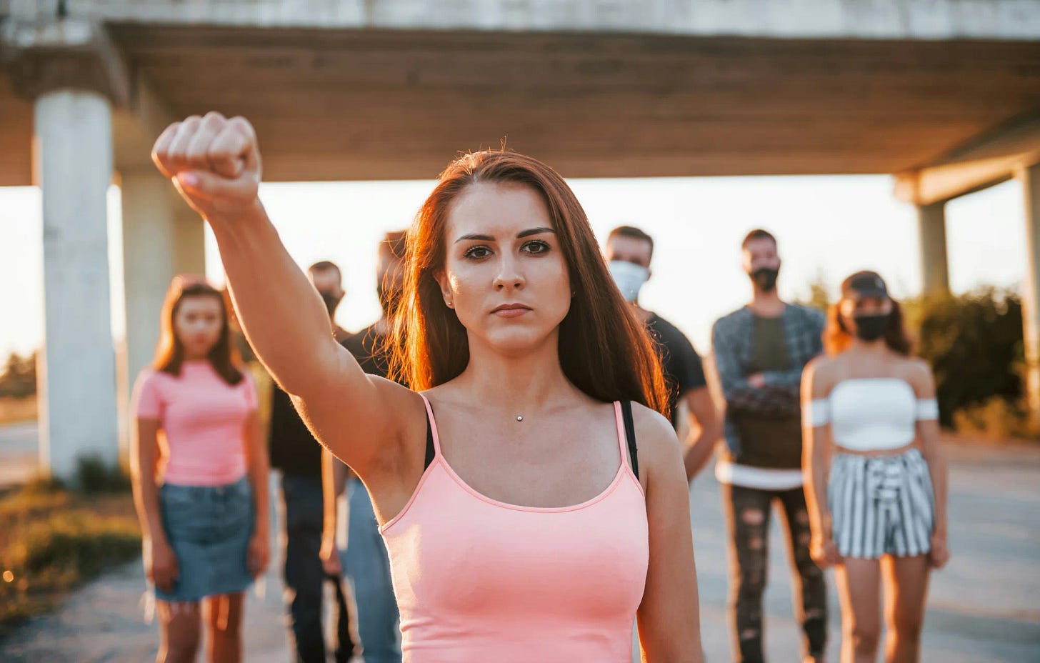 woman with her fist up and group of people behind her