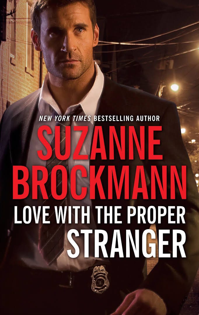 Cover art for Suzanne Brockmann's Love with the Proper Stranger features a guy in a suit with a police badge on his belt. Who is he, because he sure as hell isn't this book's undercover FBI agent hero! Wherever he is, it's night and street lights are behind him. He looks worried, probably because he's not sure why he's on the cover of this book.