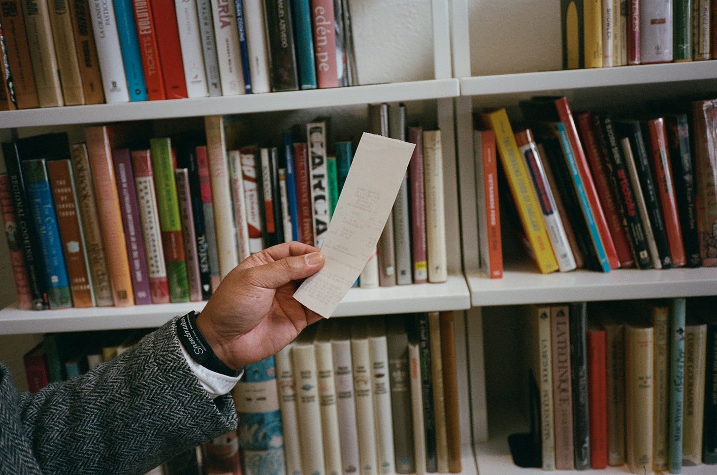Mark Aquino holds a receipt found in his first-edition copy of Anthony Bourdain’s Les Halles Cookbook Mark Aquino holds a receipt found in his first-edition copy of Anthony Bourdain’s Les Halles Cookbook