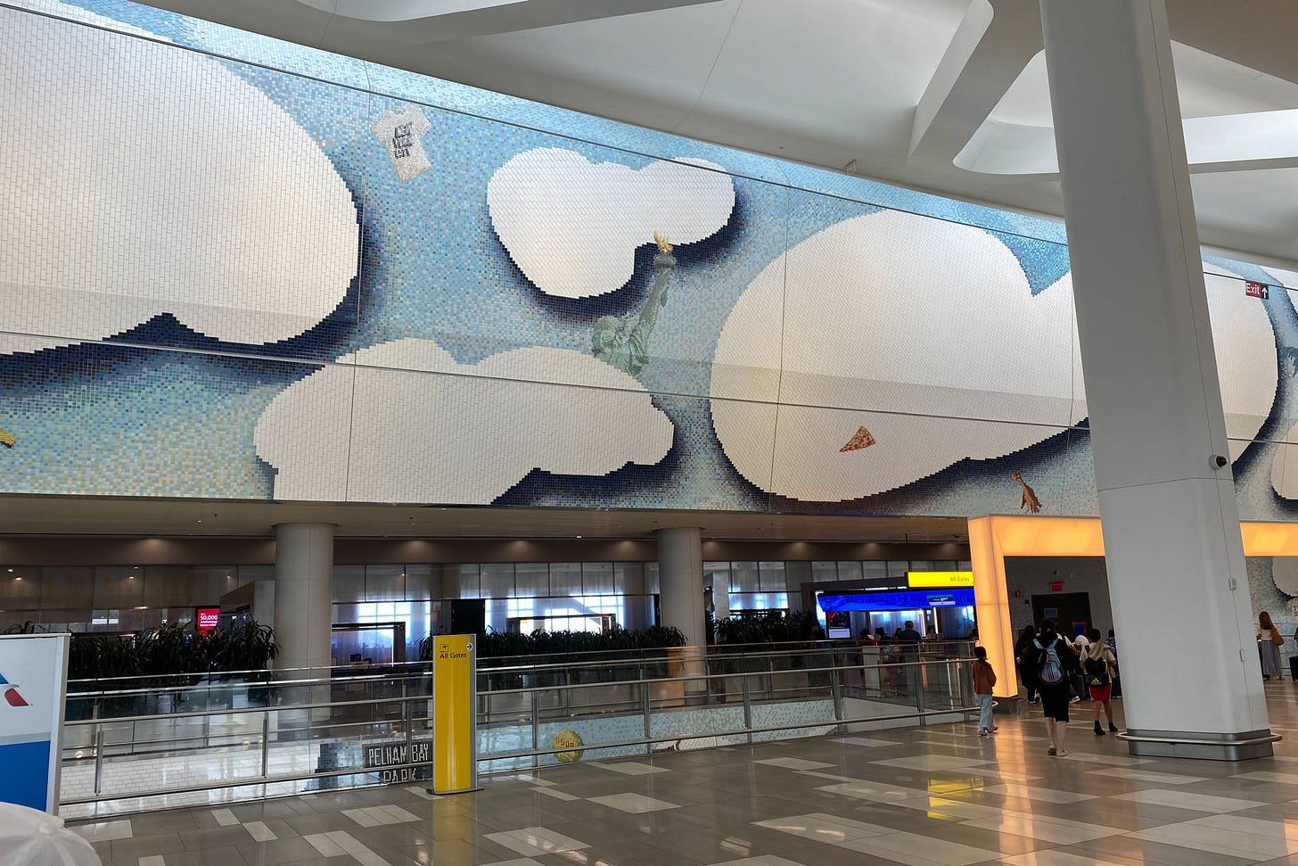 LaGuardia Airport mural of clouds with the statue of liberty and other iconic symbols