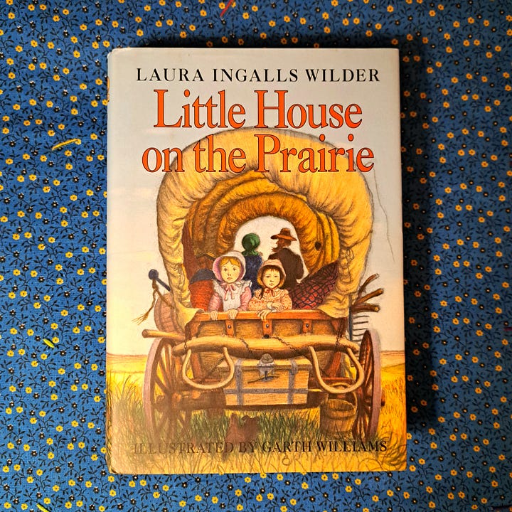Little House book on 1970s blue & yellow cotton floral fabric, vintage Anne of Green Gables paperback on wood