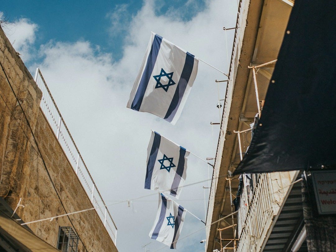 flags hanging on roof during daytime flags hanging on roof during daytime
