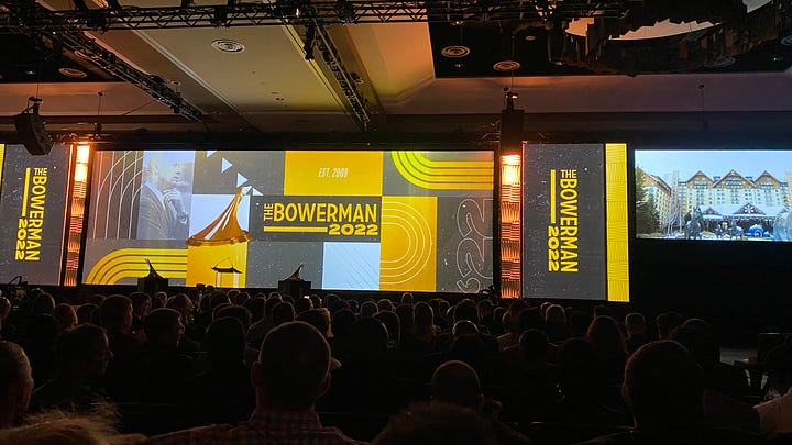 Bowerman Presentation, Portrait under USTFCCCA sign, A group listening to a presentation, Florida Palm Trees