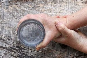 Abnormal neural synchrony underlies many neurological conditions, including Parkinson’s disease, which can cause tremors. | iStock/Astrid860