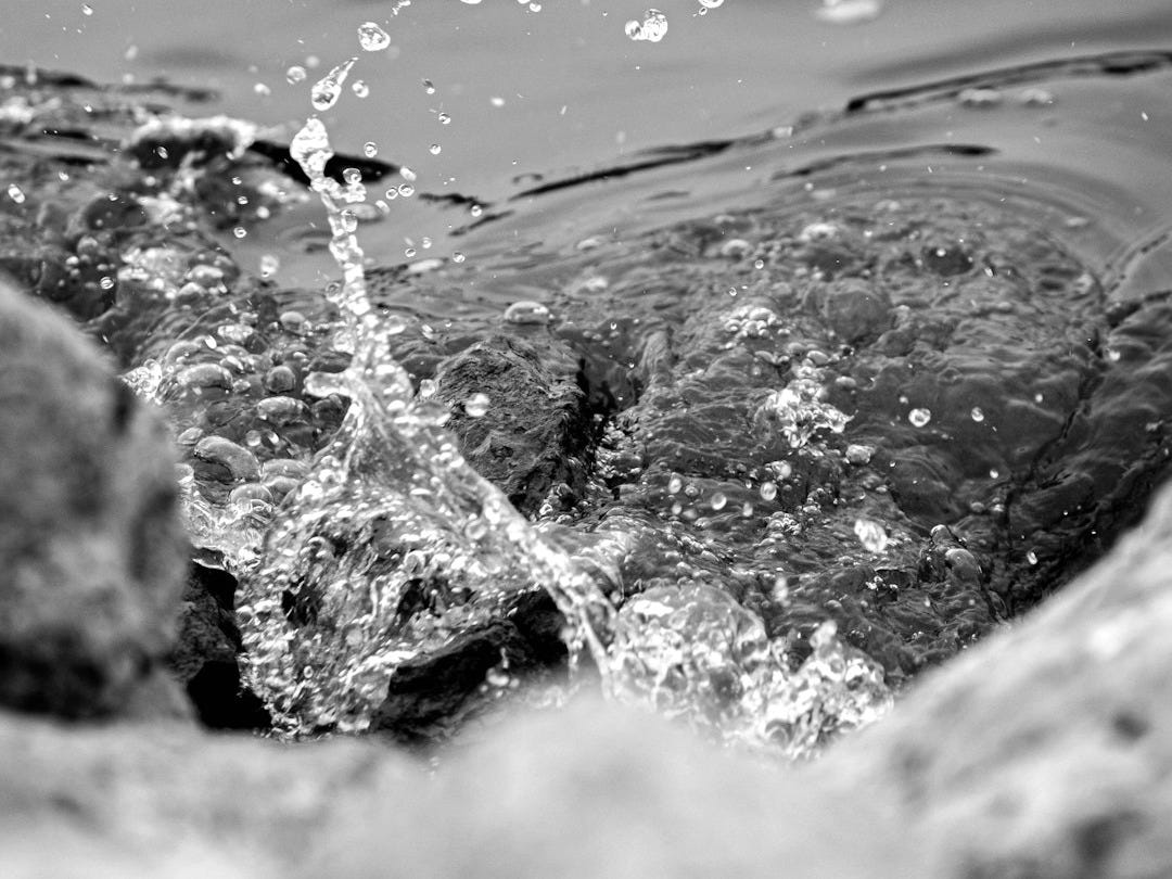 water splash on brown rock