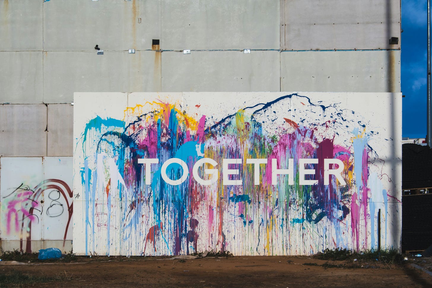 bright paint splashes and sign that says Together