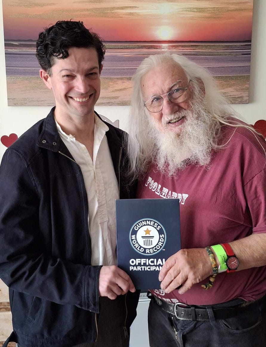 Chip Colquhoun receiving his Guiness World Record certificate from master storyteller John Row