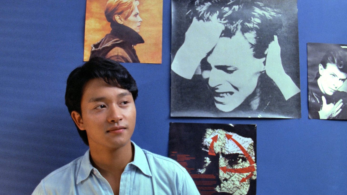 Nomad | Still features Leslie Cheung as Louis against a wall decorated with David Bowie memorabilia.