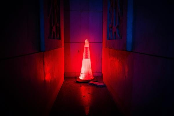 Illuminated road work cone in the dark Illuminated road work cone in the dark