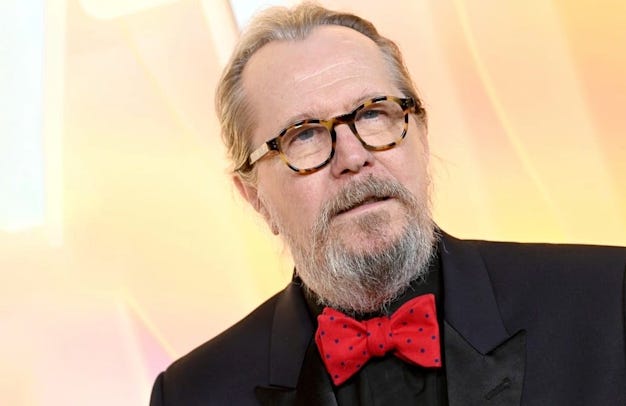 Gary Oldman wearing glasses and a bow-tie Gary Oldman wearing glasses and a bow-tie