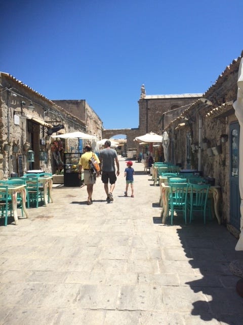 bounganvilla, coffee granita with panna colorful chair and stone buildings in Siciliy cannoli prickly pear cactus Sicily the blue sea