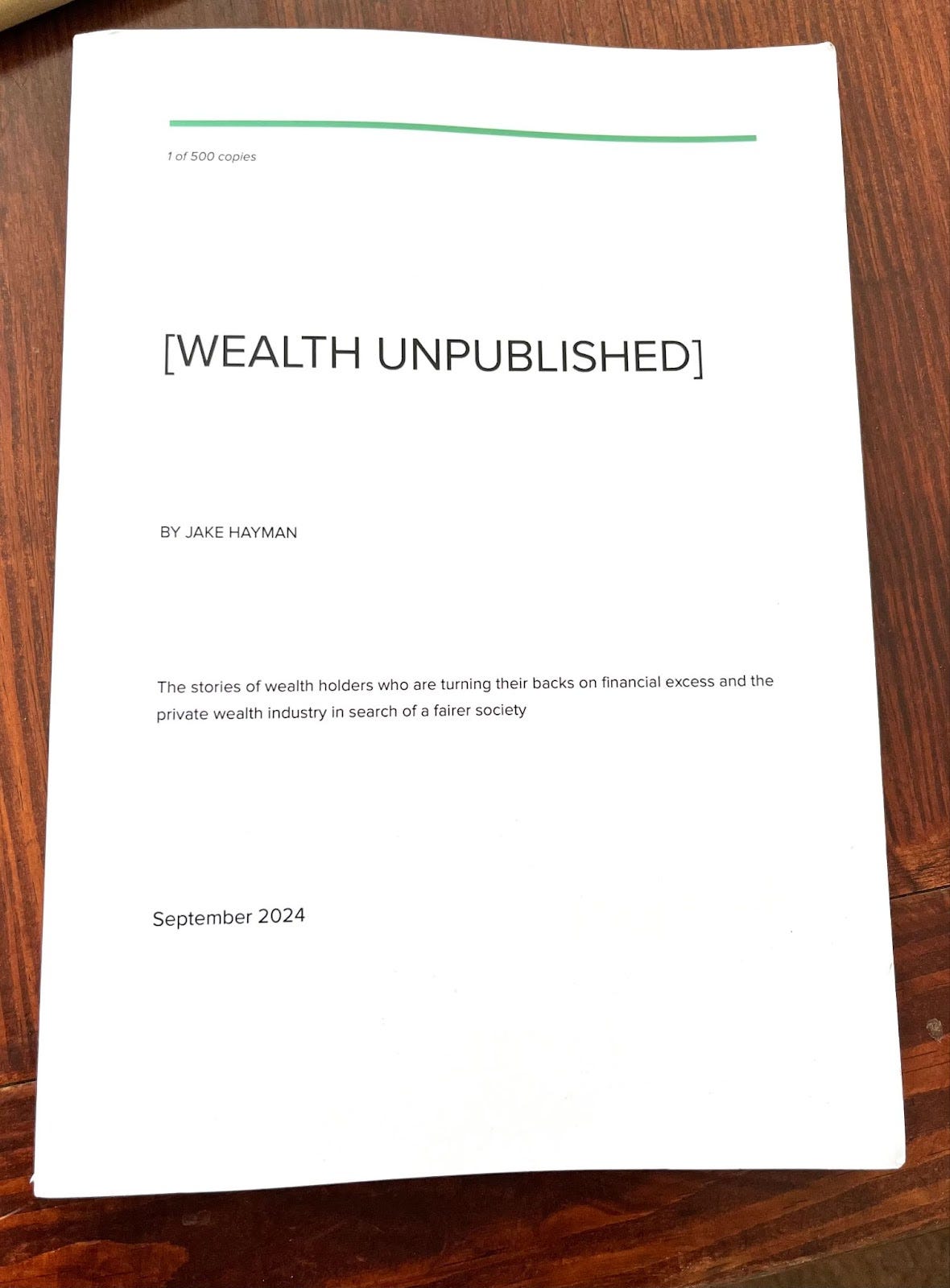 A 8x10 white printed book with the cover reading "Wealth Unpublished". It also reads "By Jake Hayman", "1 of 500 copies" and "September 2024" on the cover.