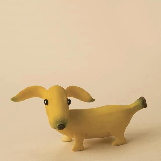 This may contain: a toy dog made out of banana peels on a white background with space for text