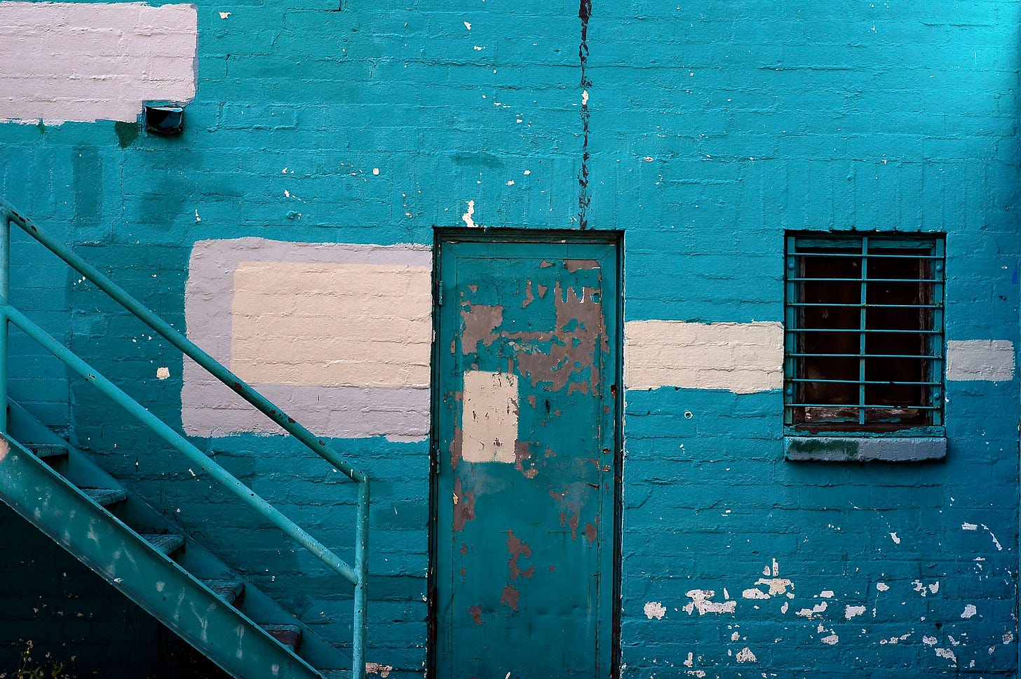 Mostly blue photograph of a door and stairs Mostly blue photograph of a door and stairs