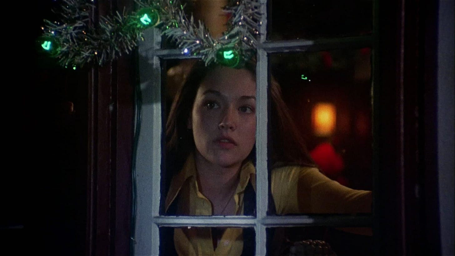 Black Christmas | Still features Olivia Hussey as Jess Bradford looking out a window.
