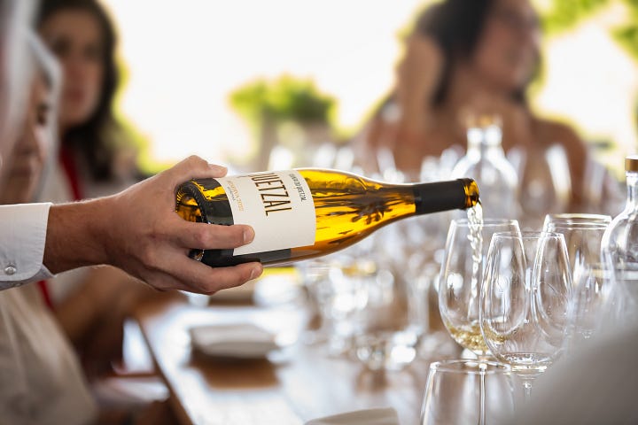 photos provided by Quinta do Quetzal winery, sommeliers pouring wine to guests