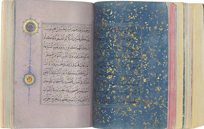 This may contain: an open book with arabic writing on the pages and gold sprinkles all over it This may contain: an open book with arabic writing on the pages and gold sprinkles all over it