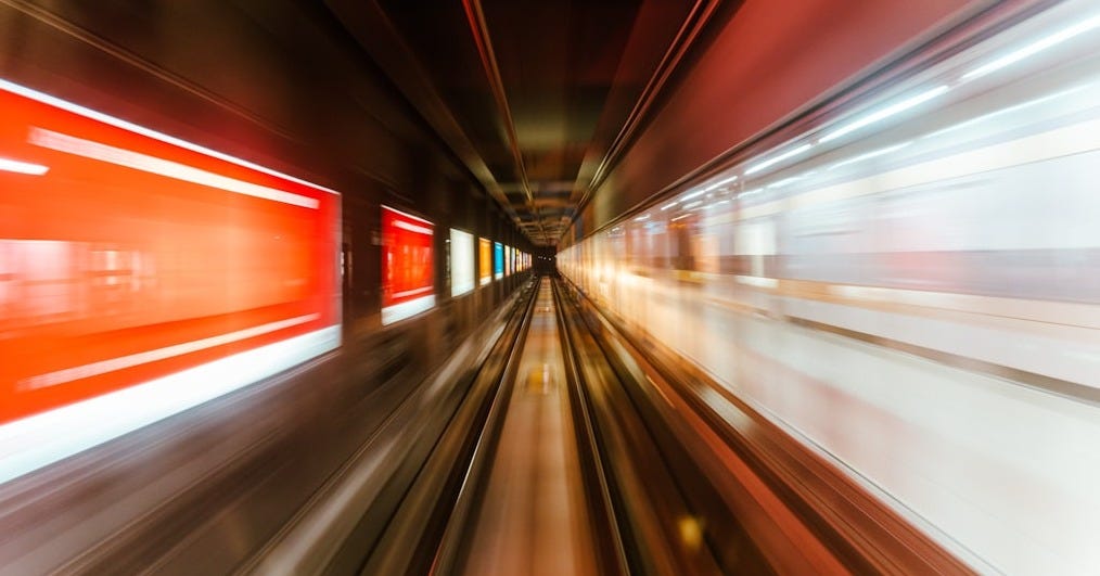 a blurry photo of a train going through a tunnel