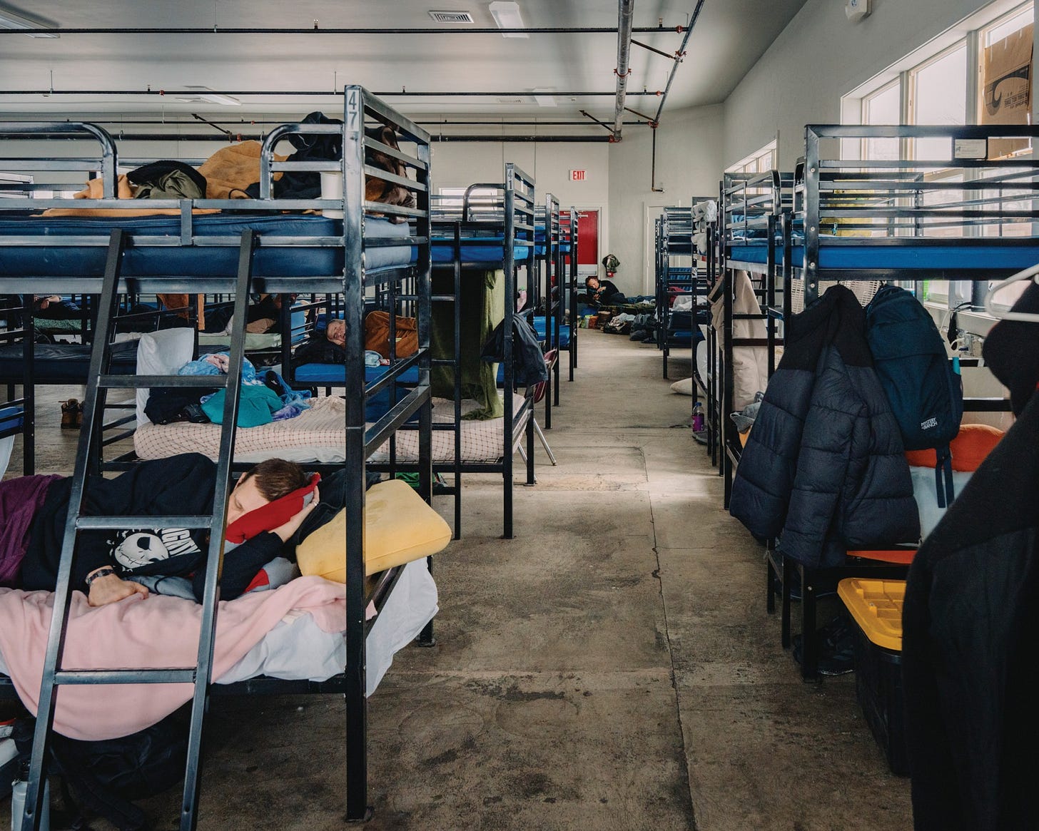 Unhoused men rest at the Warming Center on a February day when the temperature fell below 10 degrees Fahrenheit. Unhoused men rest at the Warming Center on a February day when the temperature fell below 10 degrees Fahrenheit.