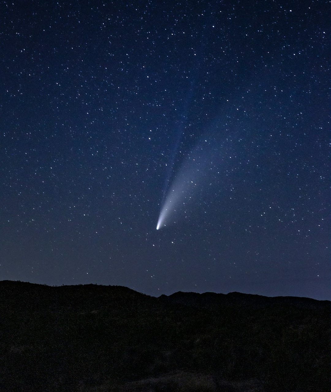 silhouette of mountain under starry night