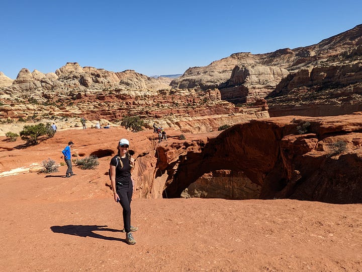 Author hiking on red rocks, posing in front of an arch. Also, photo of trees in a desert valley.